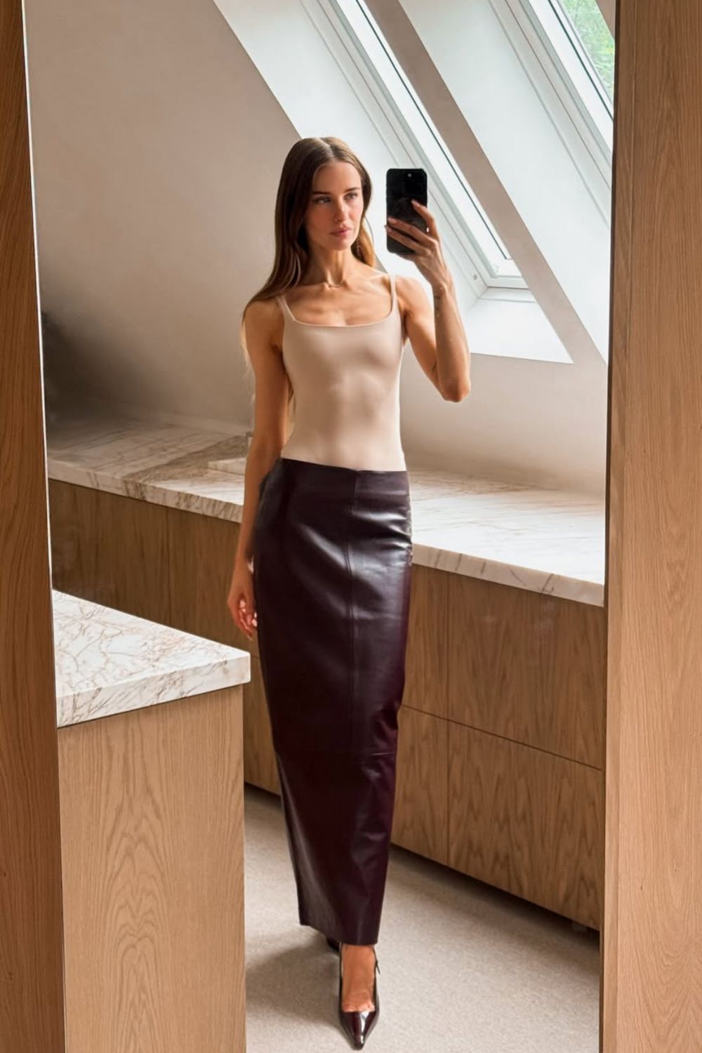 Long leather skirts are chic, versatile, and timeless. From casual street style with sneakers to bold color-block looks, discover 30+ stylish long leather skirt outfit ideas to inspire your wardrobe for work, weekends, and nights out. Perfect outfit inspiration for every season. Long Black Leather Skirt Outfit, Winter, Black, Midi Leather Skirt, Long Brown Leather Skirt Outfit, Long Faux Leather Skirt, How To Style A Long Leather Skirt, Outfits With Long Leather Skirt, Leather Midi Skirt Outfit