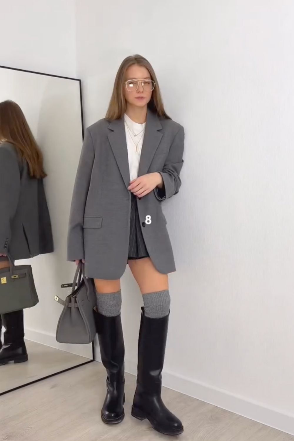 Discover 30+ chic grey mini skirt outfit ideas, from preppy layered looks to cozy knits and street-style classics. Get styling tips, seasonal inspiration, and trendy ways to wear a grey mini skirt all year round. Grey Mini Skirt Outfit Winter, Mini Grey Skirt Outfit, Grey Pleated Mini Skirt Outfit, Grey Mini Skirt Outfit Summer, Grey Mini Skirt Outfit Black Women, Grey Mini Skirt Outfit Aesthetic, Grey Pleated Skirt Outfit, Grey Satin Skirt Outfit, Grey Midi Skirt Outfit, Grey Midi Skirt Outfit