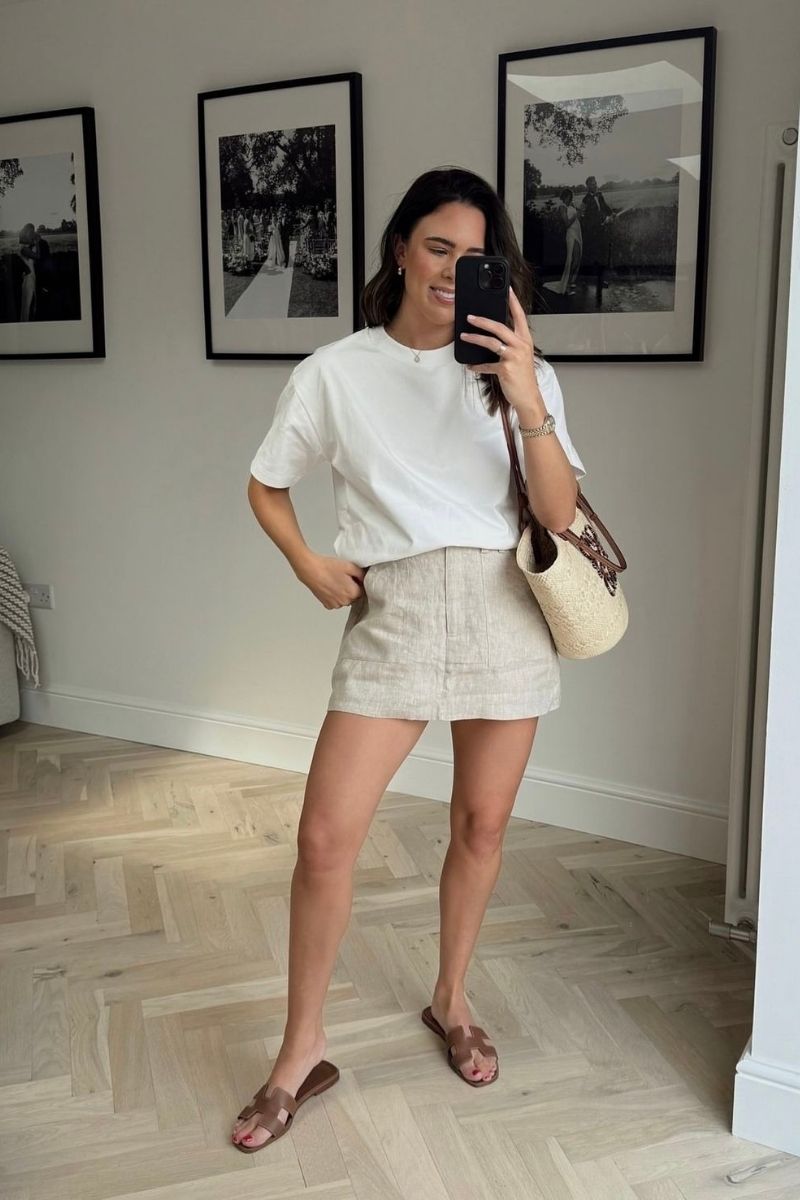 Discover the best linen mini skirt outfit ideas for summer, from chic neutral co-ords to casual oversized shirt looks and elevated vacation outfits. I’m sharing stylish ways to wear linen mini skirts with sandals, sneakers, tanks, vests, and effortless accessories for an easy yet polished warm-weather wardrobe. Linen Mini Skirt Outfit, Linen Mini Skirt Outfit Summer, Linen Mini Skirt Outfit Ideas, Linen Mini Skirt Set, Linen Mini Skirt Outfit Black, Linen Mini Skirt Outfit Black, Linen Mini Skirt And Top Set, Black, White, Sweater, Linen Mini Skirt With Boots, With Belt, What To Wear With A White Linen Mini Skirt, Short Linen Skirt Outfit Summer, Short Linen Skirt Styling, Short Linen Skirt Outfit Fall, Short Linen Skirt Outfit Casual, Plus Size, Short Linen Skirt Fits