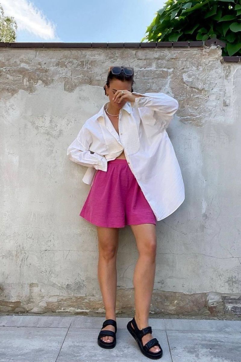 Discover chic and effortless pink shorts outfit ideas you’ll want to wear all summer long. From tailored Bermuda styles to bold hot pink looks, this guide covers how to style pink shorts with elevated basics, statement pieces, and on-trend accessories for every occasion. Pink Shorts Outfit Women, Pink Shorts Outfits Summer, Pink Shorts Outfit Ideas, Pink Shorts Outfits Summer Casual, Pink Shorts Outfits Casual, Pink Shorts Outfits Summer Street Styles, Pink Shorts Outfits Beach, Cute Outfit Ideas With Pink Shorts, Outfit Ideas With Light Pink Shorts, What To Wear With Pink And White Striped Shorts, What Tops To Wear With Pink Shorts, What Goes With Pink Shorts