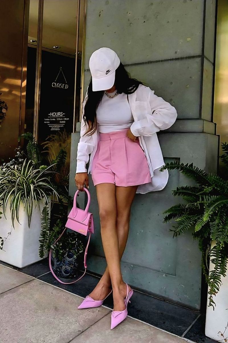Discover chic and effortless pink shorts outfit ideas you’ll want to wear all summer long. From tailored Bermuda styles to bold hot pink looks, this guide covers how to style pink shorts with elevated basics, statement pieces, and on-trend accessories for every occasion. Pink Shorts Outfit Women, Pink Shorts Outfits Summer, Pink Shorts Outfit Ideas, Pink Shorts Outfits Summer Casual, Pink Shorts Outfits Casual, Pink Shorts Outfits Summer Street Styles, Pink Shorts Outfits Beach, Cute Outfit Ideas With Pink Shorts, Outfit Ideas With Light Pink Shorts, What To Wear With Pink And White Striped Shorts, What Tops To Wear With Pink Shorts, What Goes With Pink Shorts