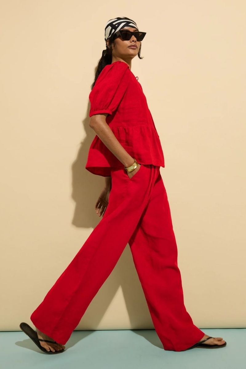 Discover how to style red linen pants with these effortlessly chic outfit ideas. From casual everyday looks to elevated summer styling, explore flattering combinations, must-have accessories, and fashion-forward ways to wear this bold wardrobe staple with confidence. Red Linen Pants With Black Top, Red Top With Linen Pants, White Linen Pants With Red Top, Linen Pants With Red Shoes, Outfits With Red Linen Pants, Red Tank Top With Linen Pants, Red Linen Pants Outfit Summer, Red Linen Pants Outfit Work, Red Linen Pants Outfit Casual, Red Linen Pants Outfit Winter, Red Linen Pants Outfit Men, Red Linen Pants Outfit Fall, Red Linen Pants Set, Red Linen Pants Beach Outfit, Red Linen Pants Outfit Ideas, Red Linen Pants Styling